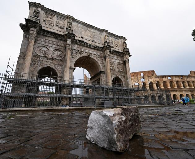 The storm dislodged a massive stone in Constantine's Arch next to the Colosseum. Photo: Reuters