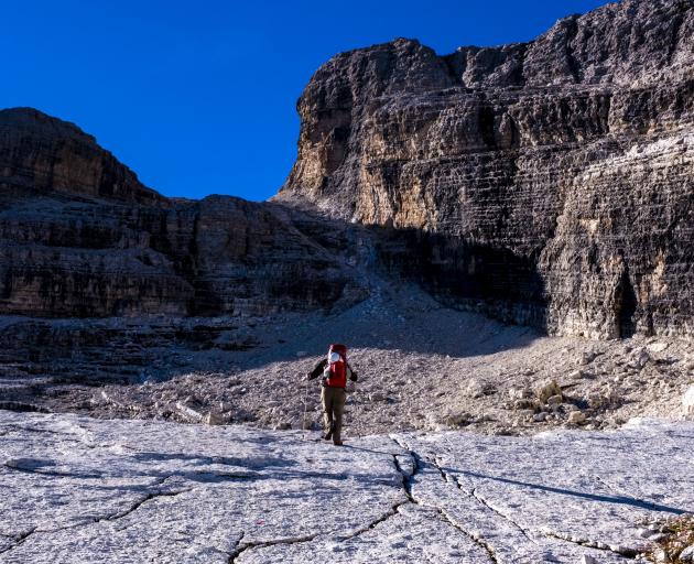 A climber walks to the starting point of the Via Ferrata.